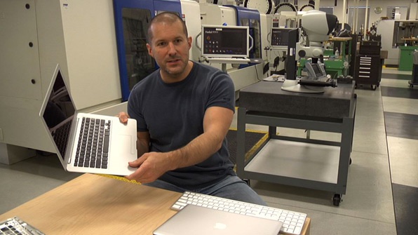 Jony Ive holding a MacBook Pro